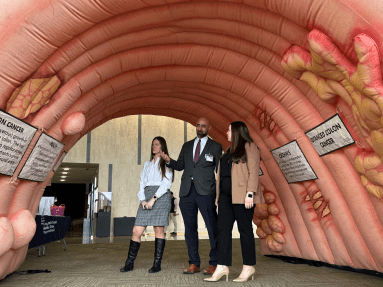 LIJ Medical center chief of colorectal surgery Dr. John Ricci (center) walks through the inflatable colon to raise awareness for colorectal cancers